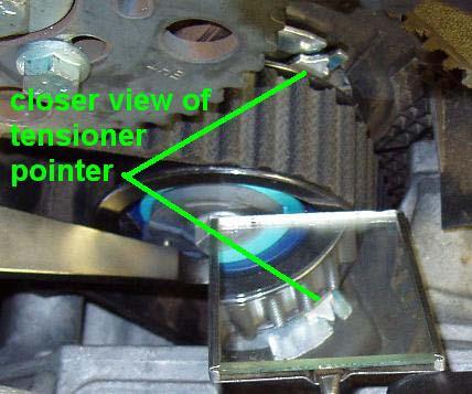 Make sure the belt routes between the tensioner and the engine mount (if the mount is not removed from the car). Now loosen the snug bolt on the cam pulley.