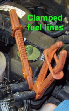 Unclip the fuel lines from the rigid intake pipe and move aside.