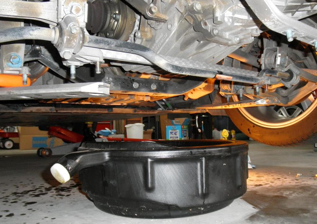 Position your receptacle to catch the gear oil under the transmission, and then carefully remove the OEM drain plug.