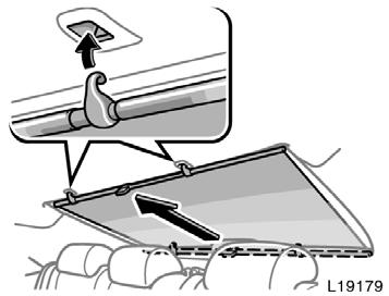 To raise the rear sun shade, pull the tab of the shade and hook it on the anchors.