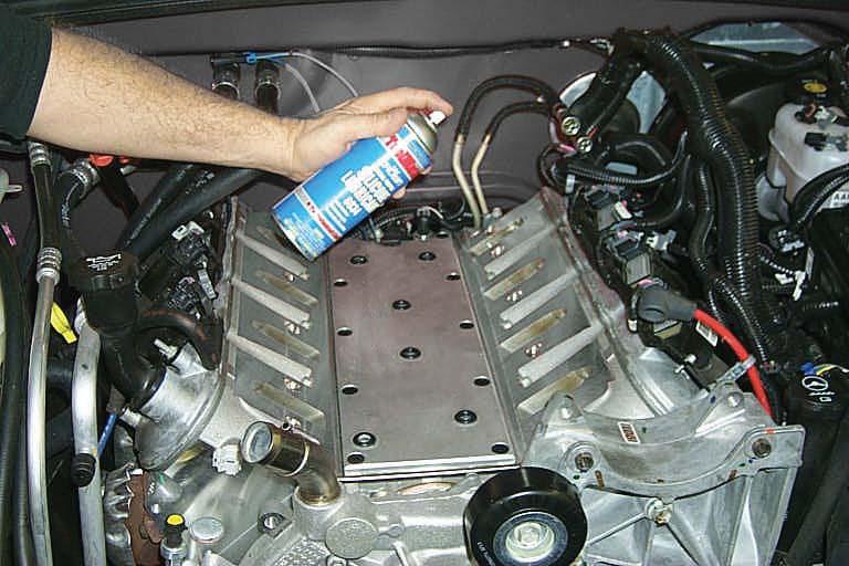 Remove tape from the cylinder head port faces and lubricate the surfaces with silicone spray or soapy water.