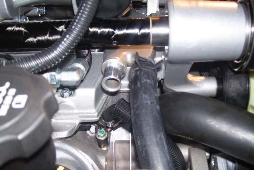 Route this hose through the radiator support and connect it to the