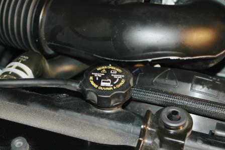 Relieve the pressure in the fuel system by depressing the check valve with a screwdriver and collecting