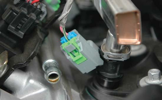 Disconnect the eight fuel injector connections by gently pulling up on the gray