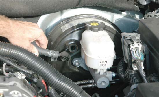 Remove the Positive Crankcase Vacuum (PCV) hose from the barb at the rear of the valve