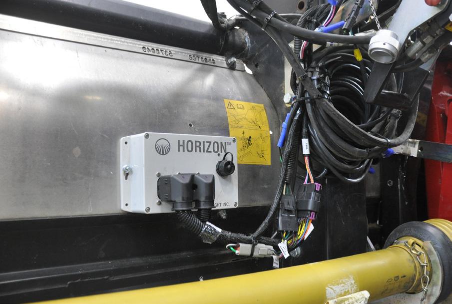 Hold the box at rear of header as shown and make sure Headsight harness can reach feeder house