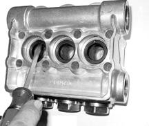 1) With a socket wrench, remove the three discharge valve plugs and three inlet valve plugs (32).