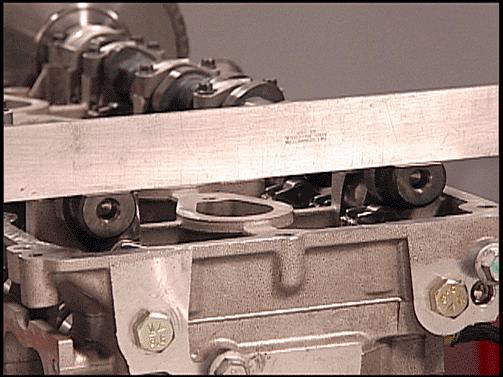 15. To verify timing, set a straight edge across the flats of the camshafts. Refer to the above illustration View A. Both camshaft flats should be flat.