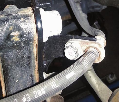Clip the wheel speed sensor harness into the supporting bracket on the strut (Fig.