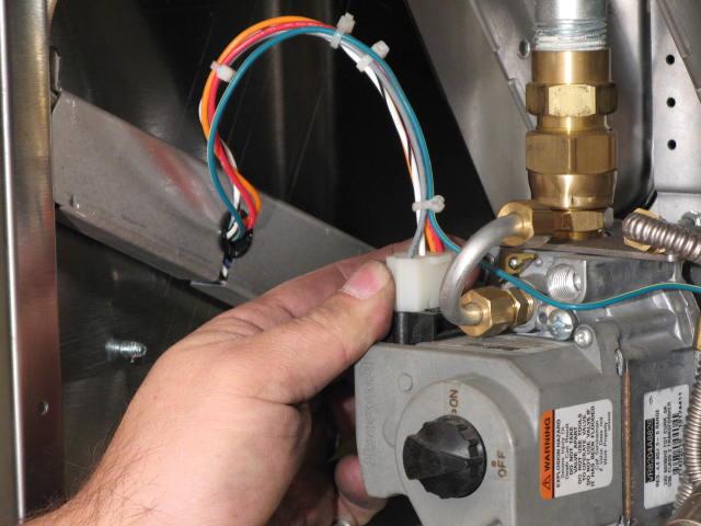 Holding the elbow with a wrench, remove the swivel nut on the bottom gas valve fitting
