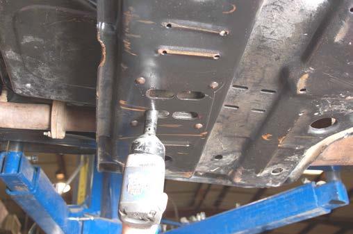 Remove the upper control arms from the rear axle using a 15mm socket / wrench. Retain axle hardware for reuse. 21.
