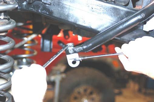 Do not over tighten stud bushing. Tighten the bar pin on the bottom of the shock with the stock hardware using a 12mm wrench. 47.
