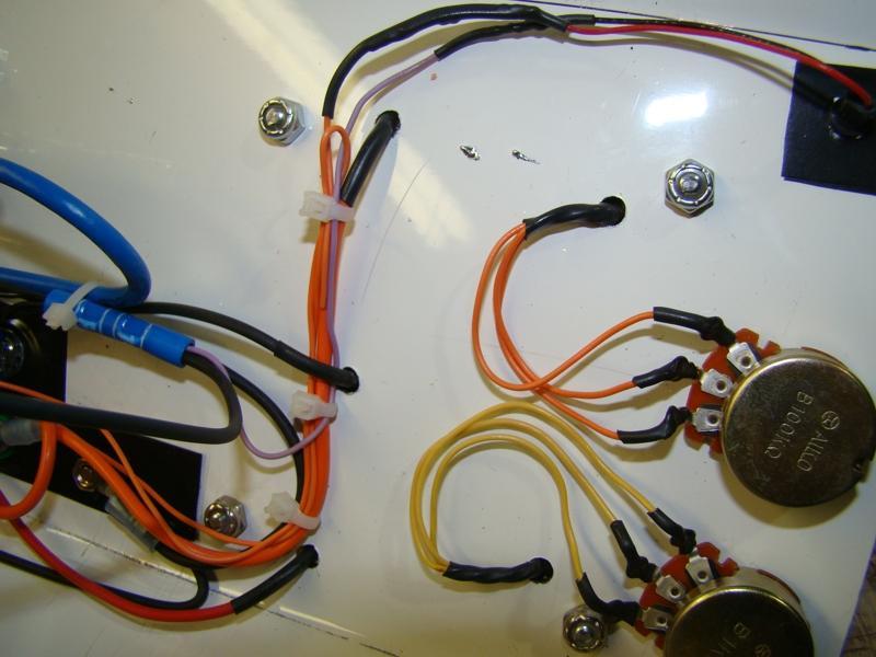 Here is the back side of the POTs and the wiring to the bread board. Towards the right you can see a Orange, Black, and red wire going into threw the cover. These are power feed to the bread board.
