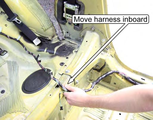 Unfasten the harness retaining clips from the vehicle and pull the harness inboard to clear the
