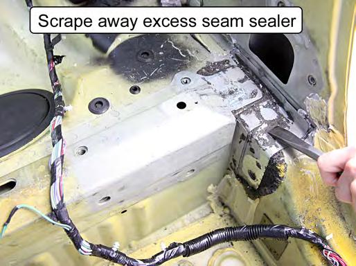 Scrape away any excess seam sealer around the factory support bracket mounting area.