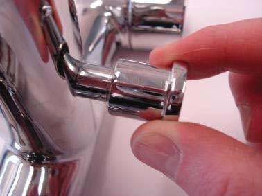 Do this by placing a flat head screwdriver into the base of the diverter valve on the underside of the spout (to stop it spinning whilst you unscrew the