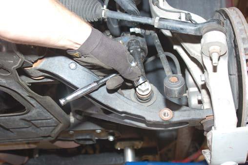 Using a hammer slightly tap the upper tie rod mount to loosen taper. See Photo 13 & 14.