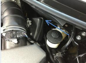 Locate the large vehicle harness grommet on the driver side.