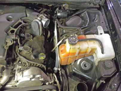 2. Removal of stock system a. Remove the bolt securing the OEM air box, and loosen the hose clamp at the throttle body. b. Pull to remove the crankcase breather hose from the nipple on the head cover.