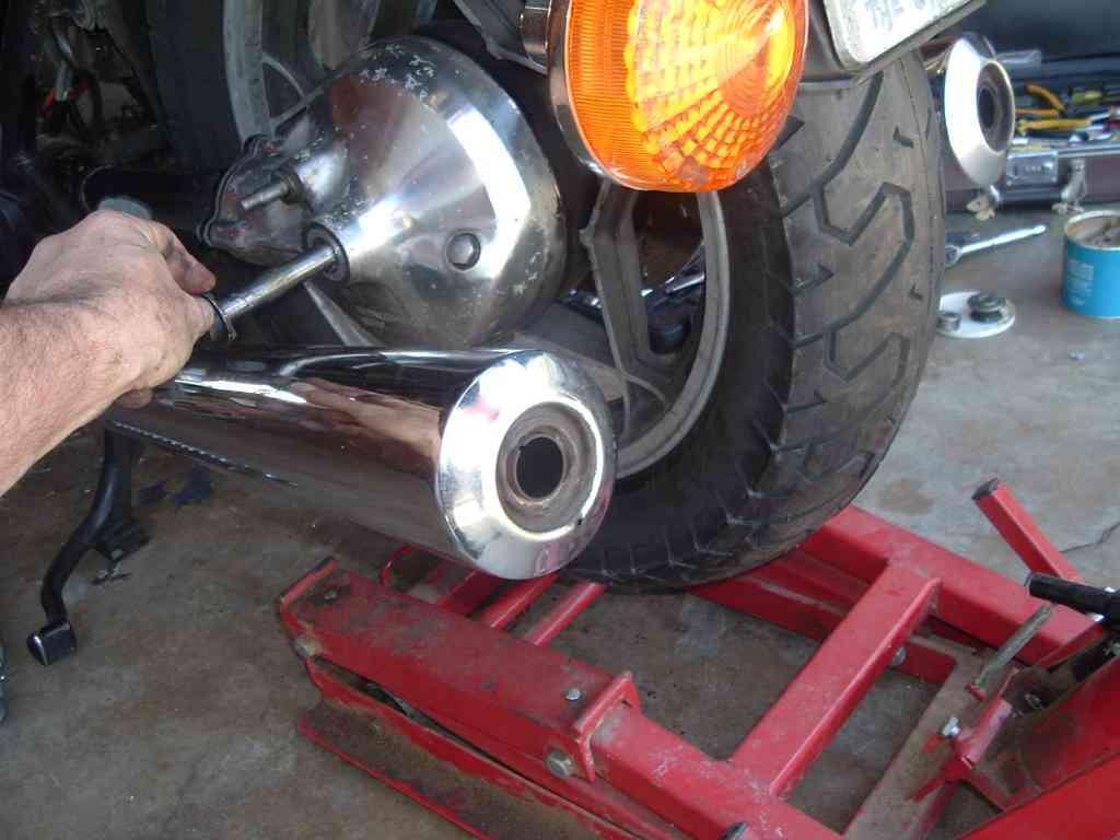 At this point, if you've put a screwdriver in the swingarm lock holes, you may wish to let it loose so that the swingarm can be manipulated more easily while mounting the wheel.