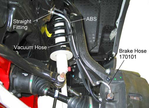 4) Disconnect the brake hose from the tubing. Plug tube to prevent brake fluid seepage. Remove the retainer clip and bracket. See illustration 18.