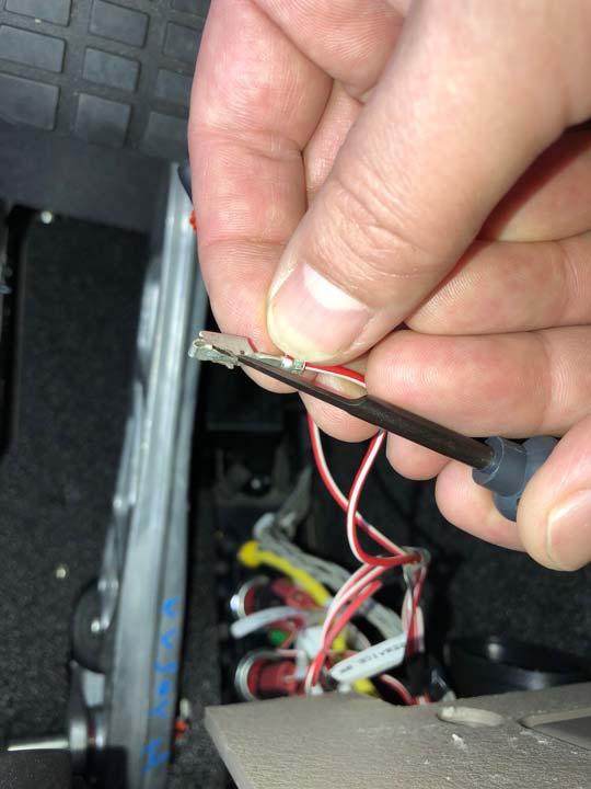 8. Cut the green seal off of the pin that was removed. 9. With the seal removed, use the automotive connector terminal removal tool to retention the latch on the pin.