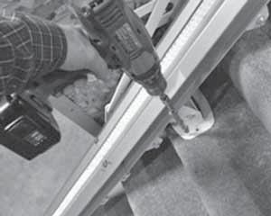 Pinnacle 101 Stair Lift FOLDING RAIL INSTALLATION 7. Fasten down the near corner of the lower bracket using a drill that has extensions at least 10"long and a 3/8 socket.