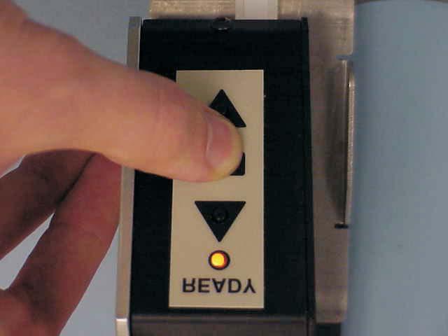 2. Hold down the Center Button on the Control Panel until the Status