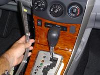 Remove lower trim on both sides of center console. (Fig.