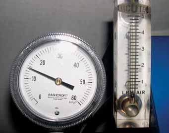 6. This original Vacutec smoke machine is equipped with a flow gauge. An inches of water gauge was attached to the unit to measure its maximum pressure. The gauge reads 14 in.