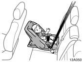 Never install a rear facing child restraint system on the front passenger