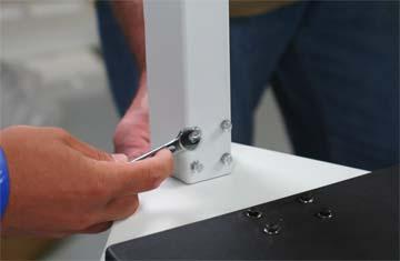 Using the wrench provided, insert and tighten the eight bolts and washers to secure the pillar to scale base.