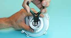 Use a flat blade screwdriver to gently pry the Main Pipe Holder from the Fan