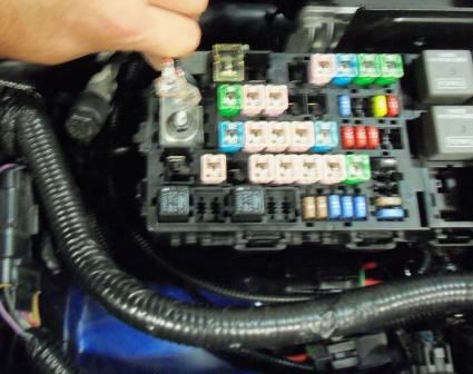 34) Attach both red wires from the fuse holders to the main power distribution of the fuse box (Fig. 13).