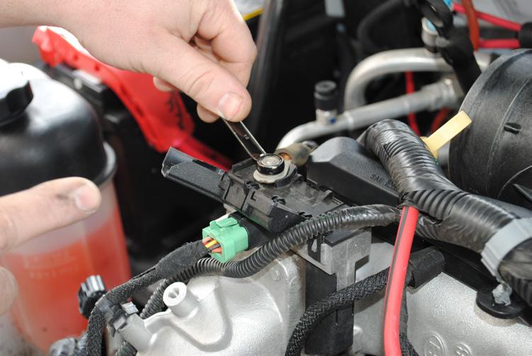 and remove the plastic clip that holds the wiring harness to the