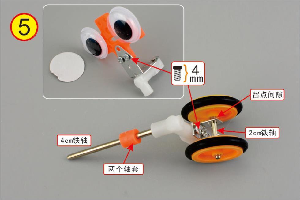 Install the robot eyes and small wheels as indicated. Pasang mata robot dan tayar kecil seperti gambar.