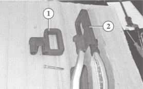 (2) and press in Removing the handle shells Loosen the Torx screw (1) and unscrew Take the two