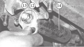 Position the handbrake lever vertically Place the spring cylinder (14) secured with the washers (12) and nut (13) in its mounting and move