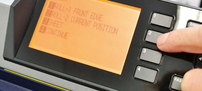 While holding down the media in the aligned position, pull up the handle on the rear of the plotter to keep the media loaded. Press button 2 as requested on the plotter s display.