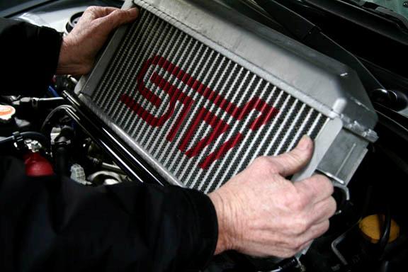 Carefully pull the intercooler up and out of the engine bay.