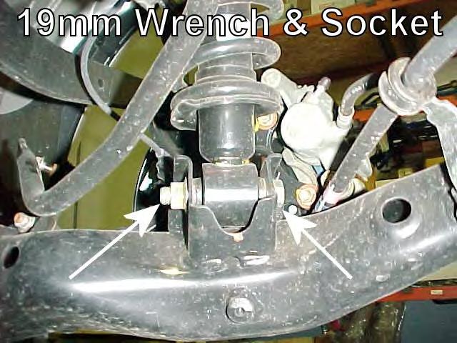 4) Remove the nut and bolt that secures the bottom of the shock to the lower control arm using a