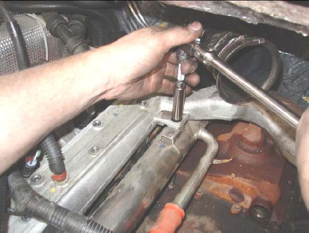 Step 15: Remove the bolt that is used to stiffen the heater tube to the manifold (located
