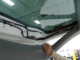Unplug the 10- pin connector from the rear of the vehicle s mirror, use a T20 Torx bit to loosen the screw securing the mirror, and slide the mirror off the windshield mounting tab.
