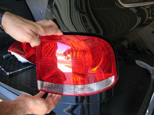 Get the tips of your fingers in the seams above and below the taillight housing and pull straight backwards,