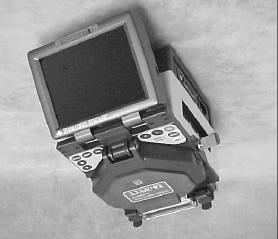 A shrinkable reinforcing sleeve is then applied and shrunk in the built-in heater to protect the completed splice. Figure 1. Type 65 Fusion Splicer 1.