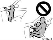 Do not allow a child to stand up, or to kneel on the front passenger seat. The airbag inflates with considerable speed and force; the child may be killed or seriously injured.