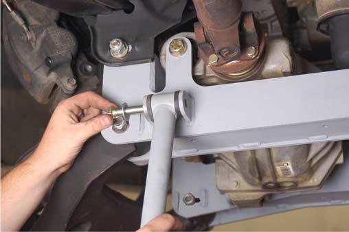 33. Install the supplied sleeves in the sway bar links and install on the sway bar and control arm using 19mm wrench and the supplied 12mm x 65mm bolts, washer s and flange lock nuts. See Photo 32.