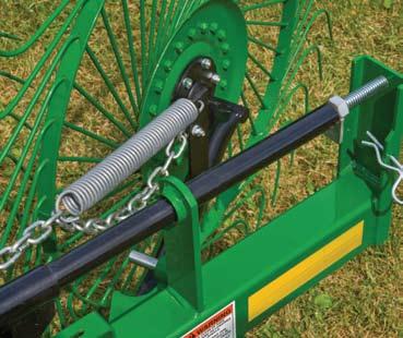 Pull the rake wheel lock-up pins to lift rake arms and release the 3-wheel expansion for efficient center windrow