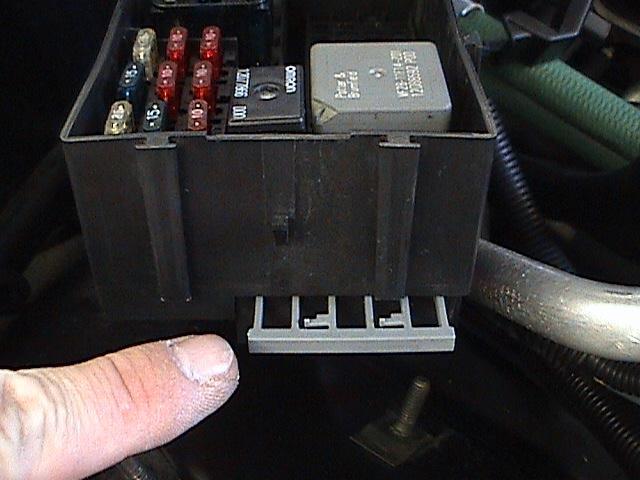 15. Reinstall the Grey locking tab. 16. Remove the second Grey locking tab on the end of the fuse panel. Grey locking tab on end of fuse panel.