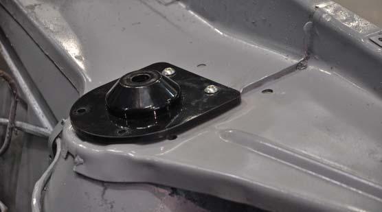 The coil-over upper mount plate installs with the fl at edge toward the outside of the car as shown. 21.